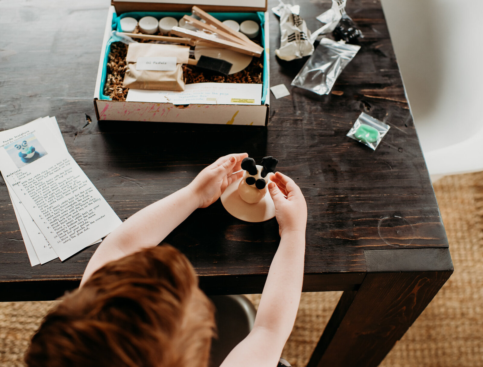Branding Photographer, a child assembles something with a box of crafting tools