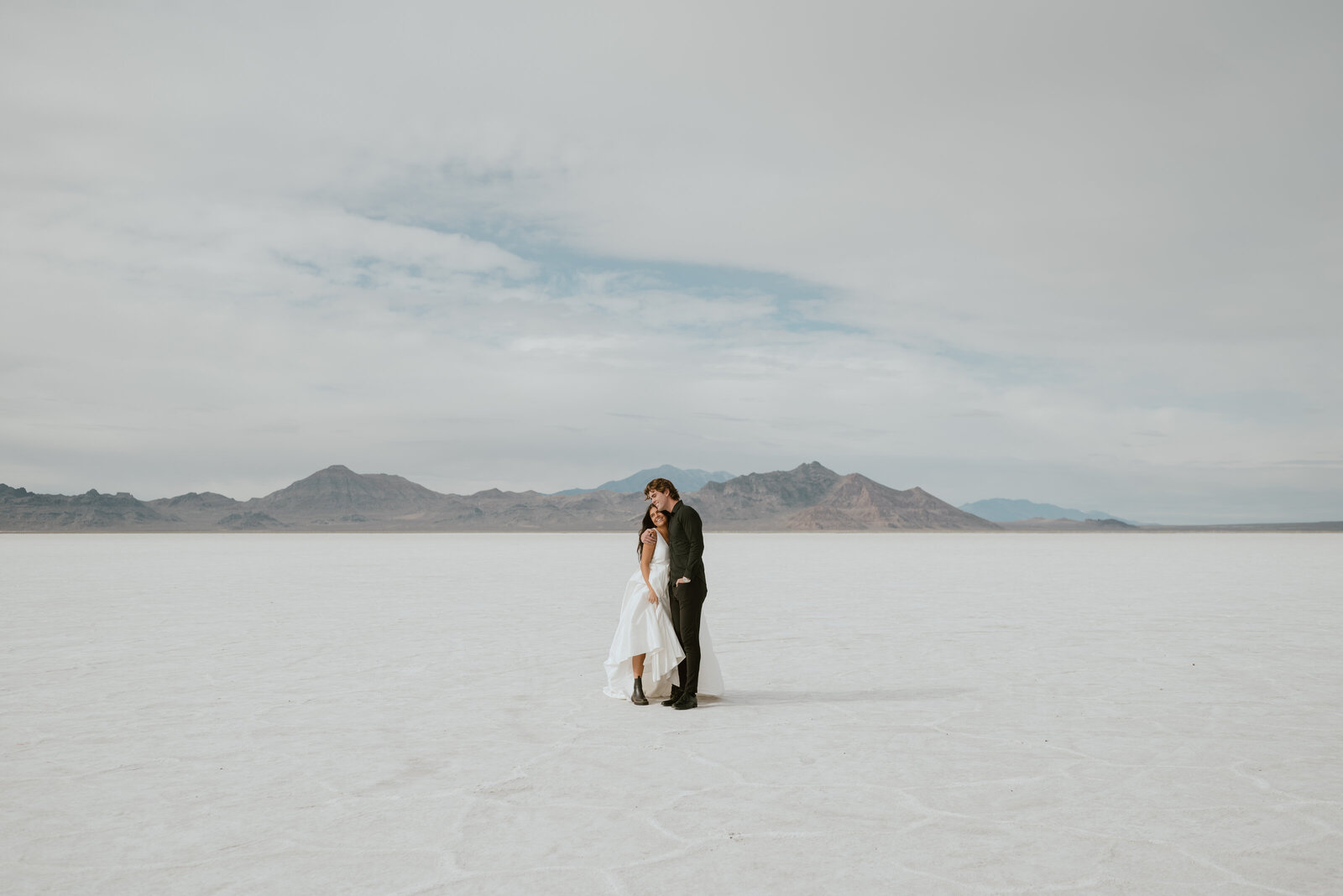 An elopement couple walks together through the Bonneville Salt Flats near Salt Lake City, Utah.