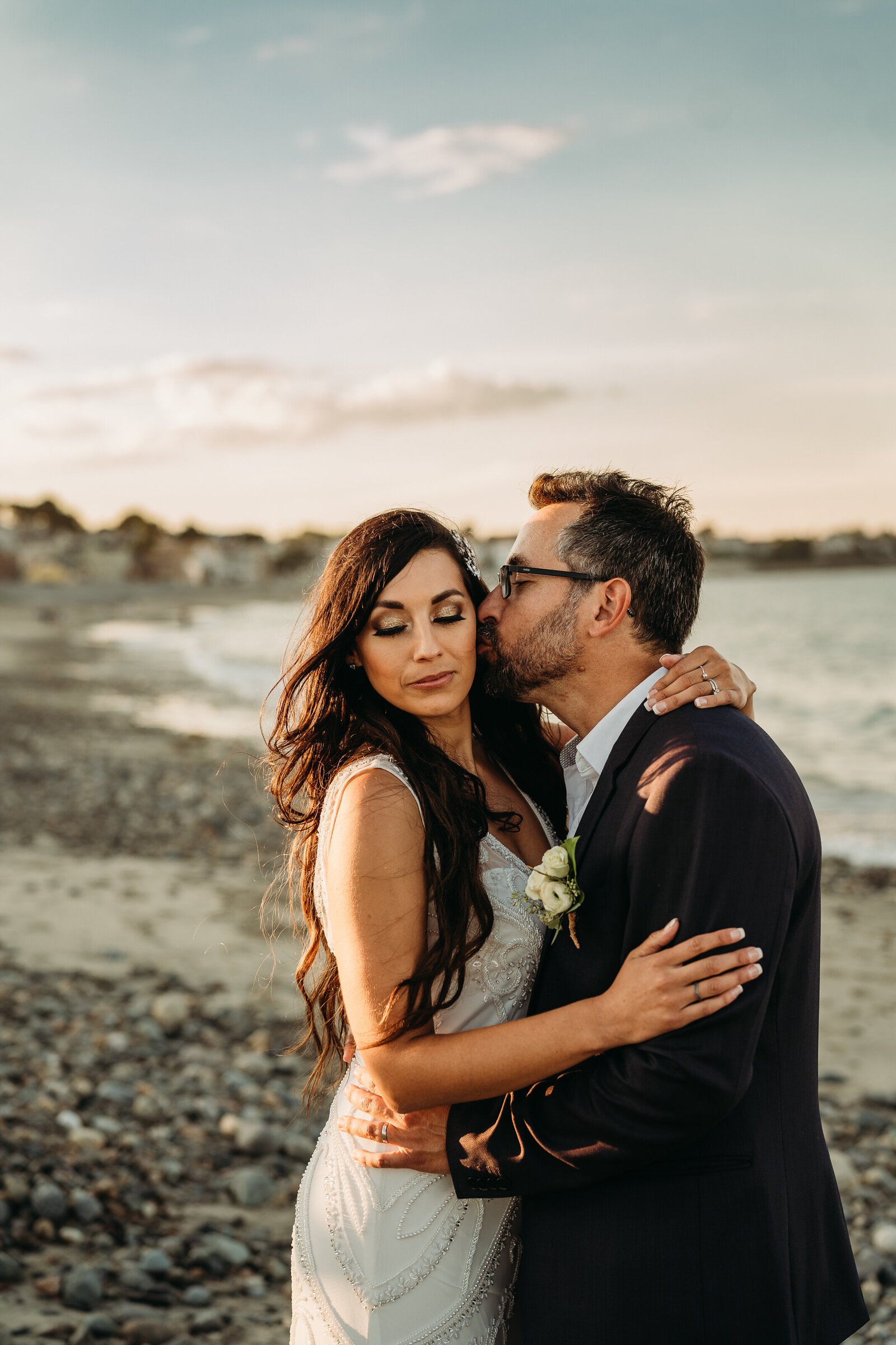elopement couple kisses on boston beach at sunset