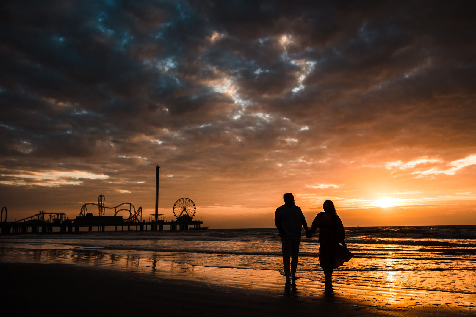 Couple celebrate their engagement  during the sunrise at Galveston Beach in Texas.