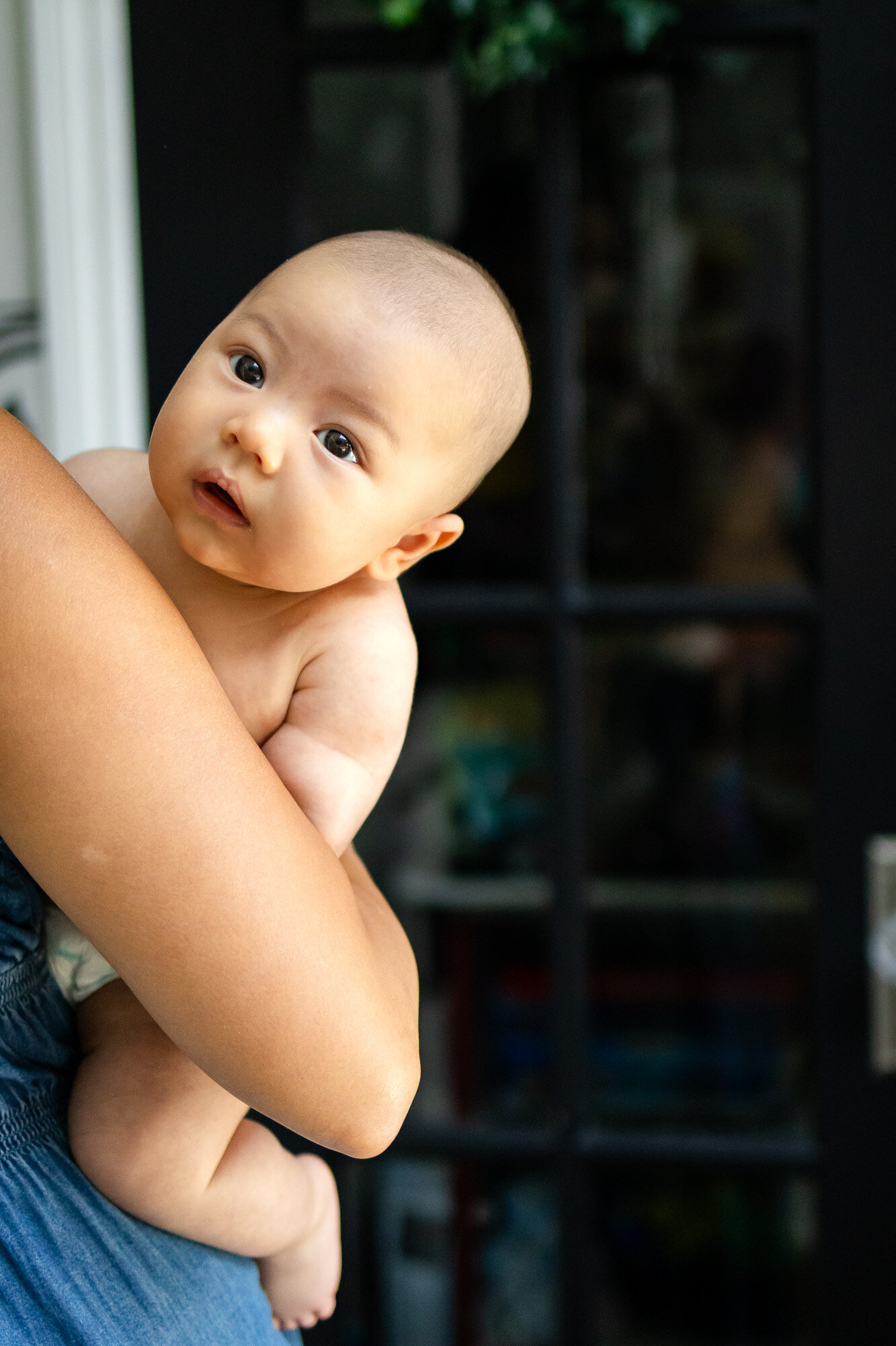 Close-up of baby resting in mother's arms, captured by San Francisco newborn photographer.