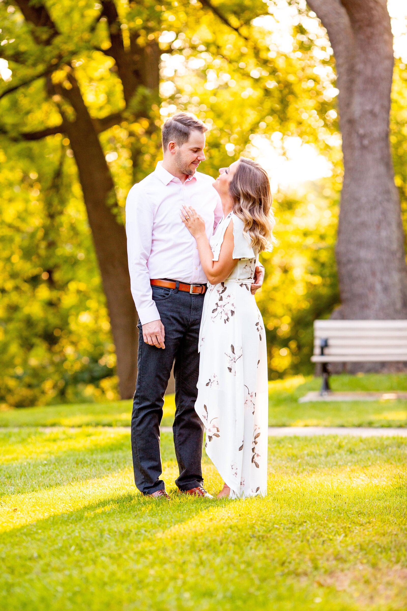 Couple look at each other during spring engagement session.