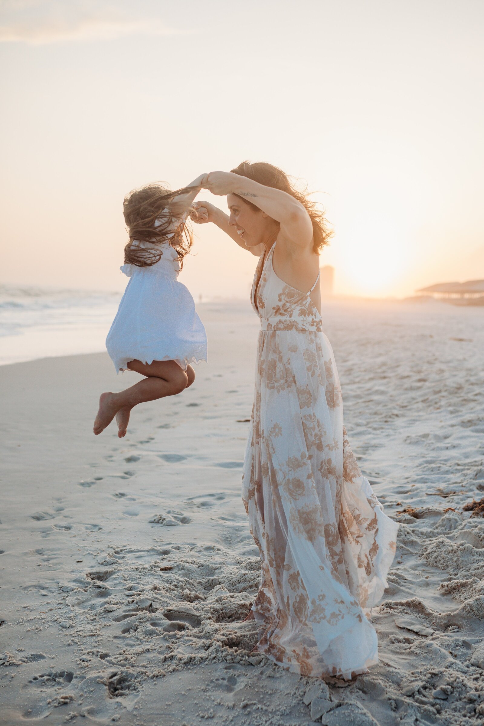 Pensacola Beach Family  Photo Session. Mother and daughter playing together at sunset on Johnson's Beach.