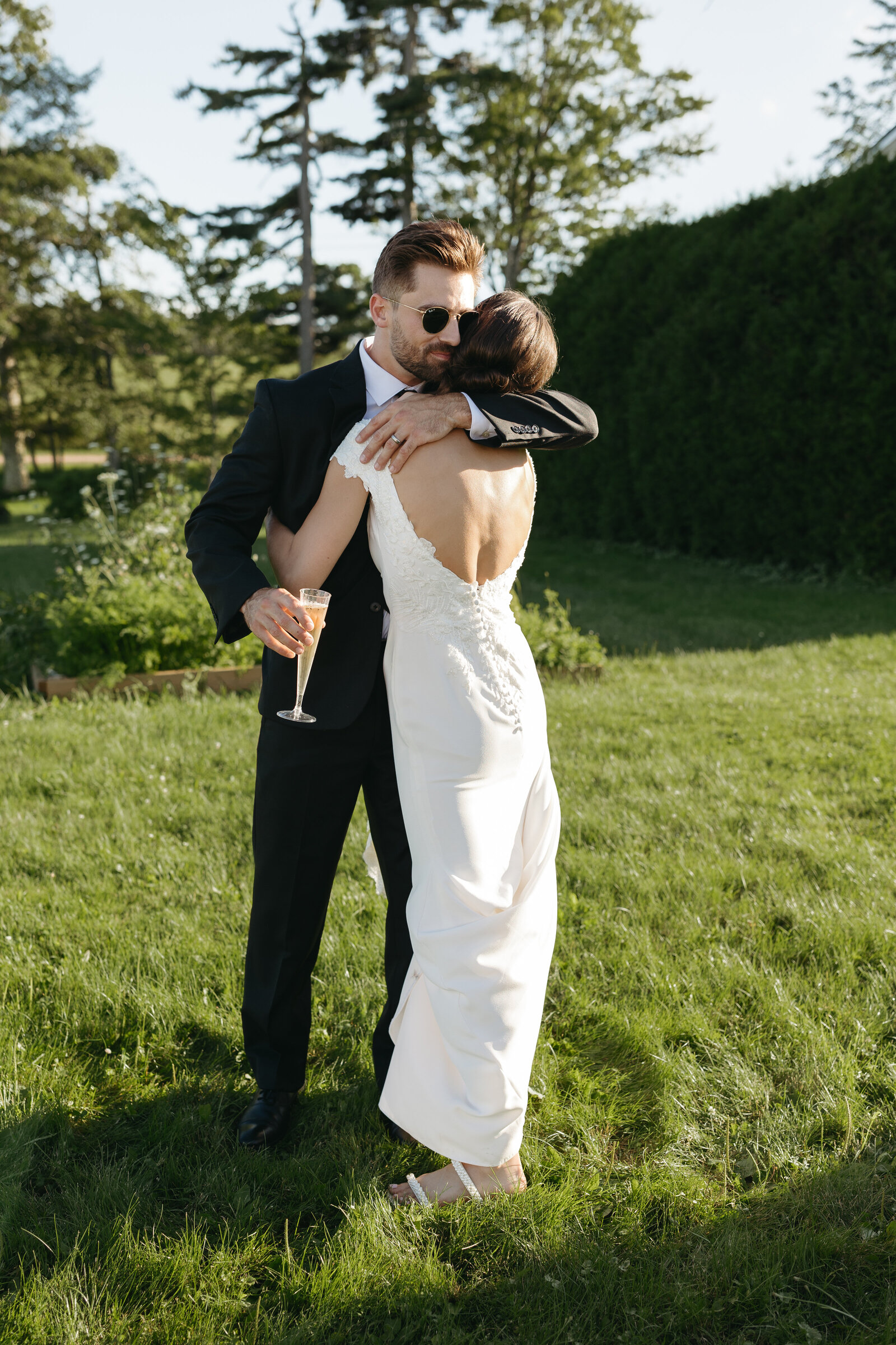 A bride and groom share a hug after getting married at the Cloverbard in Nova Scotia. 