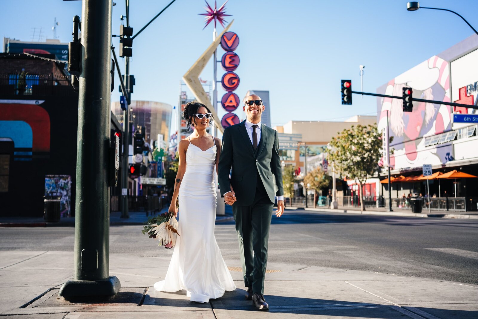 Newlyweds, hand in hand, taking a romantic stroll in downtown Las Vegas.