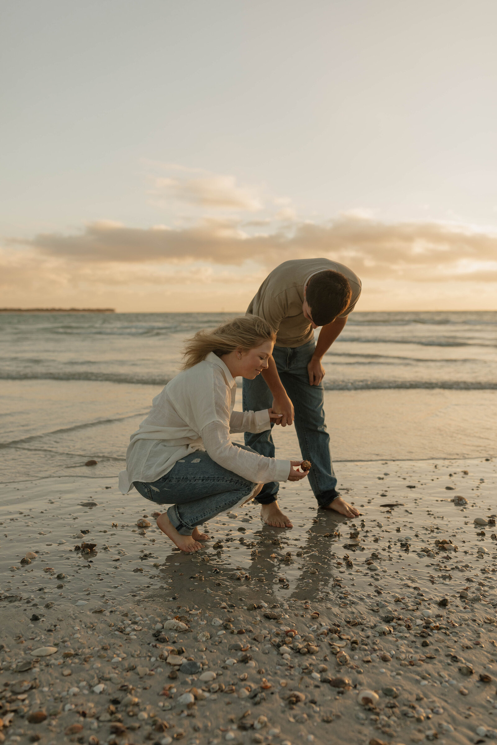 Couple during a beach photography shoot at a beach during sunset.