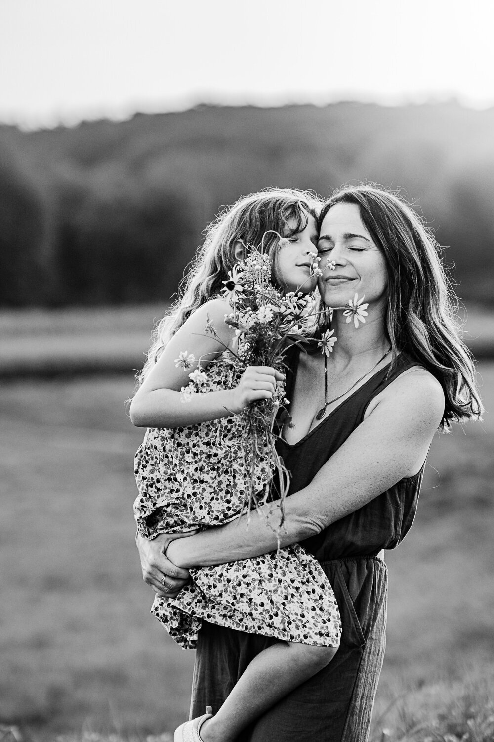 black and white portrait of mom holding daughter