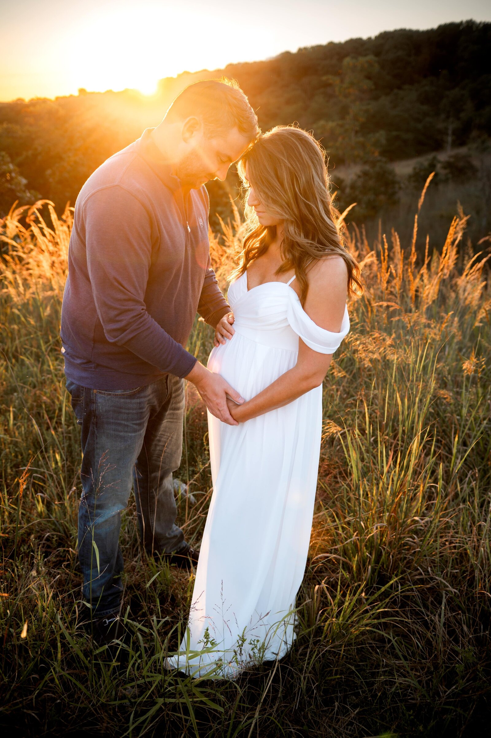 husband and wife in field at soldiers delight during a maternity session