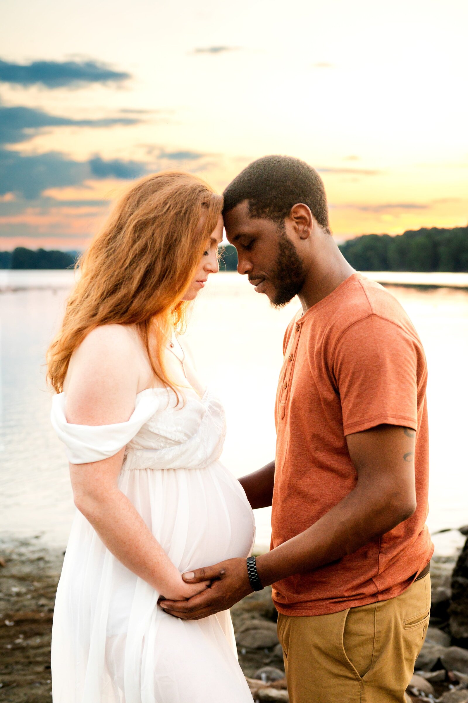 husband and pregnant wife sunggling