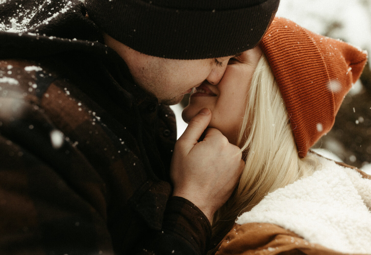 Couple almost kissing next to a waterfall