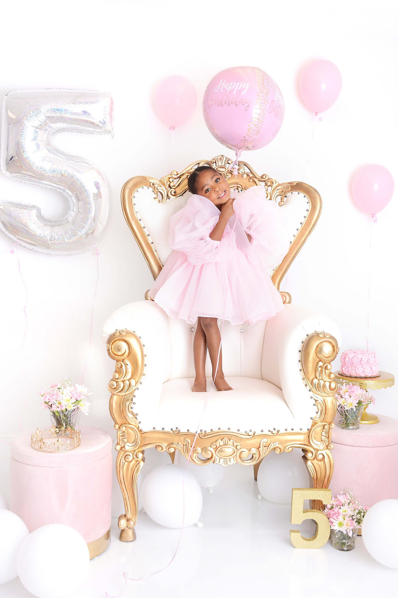 girl smiles at her 5th birthday photoshoot at a studio in houston