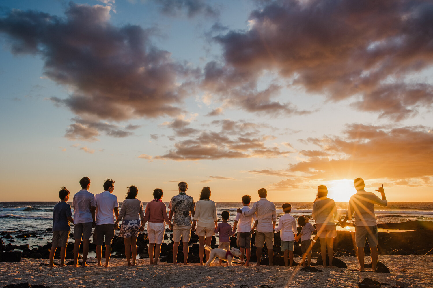 extended family in hawaii watching sunset