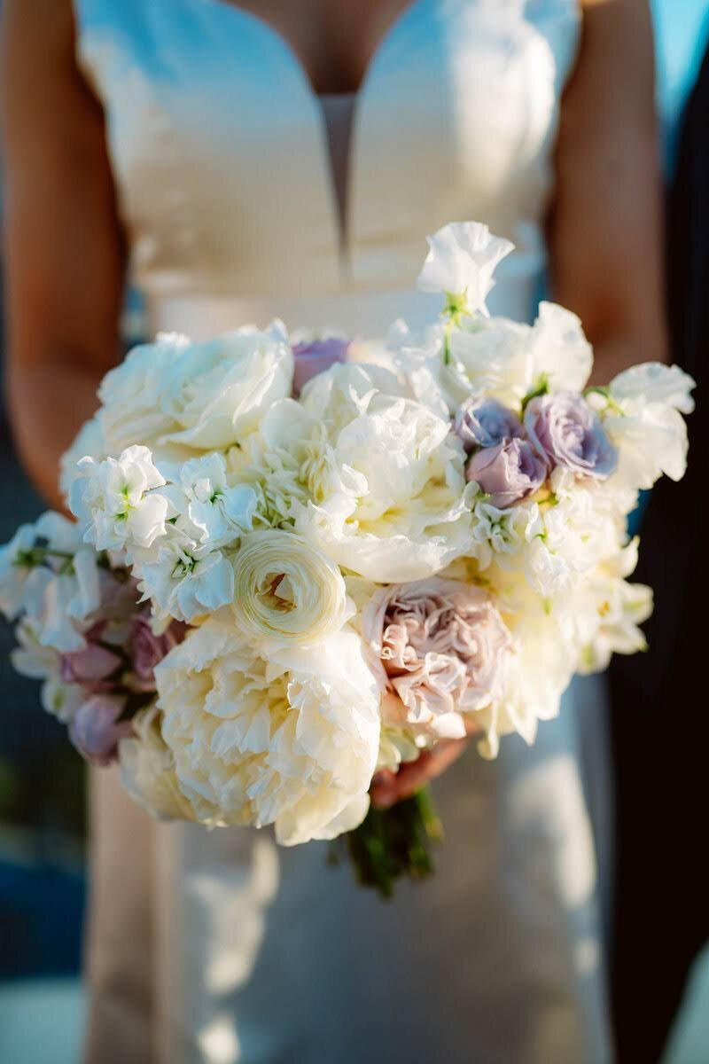 Bridal bouquet with white and purple flowers and an example of design in the florist portfolio for Flowers and Thyme.