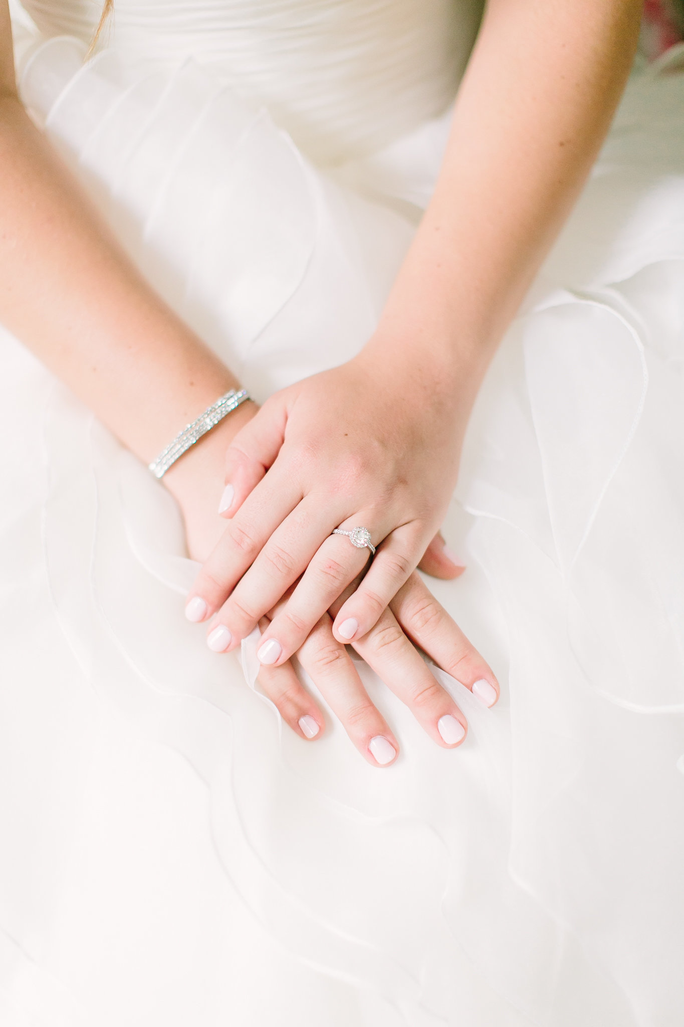 brides hands with diamond bracelet and ring