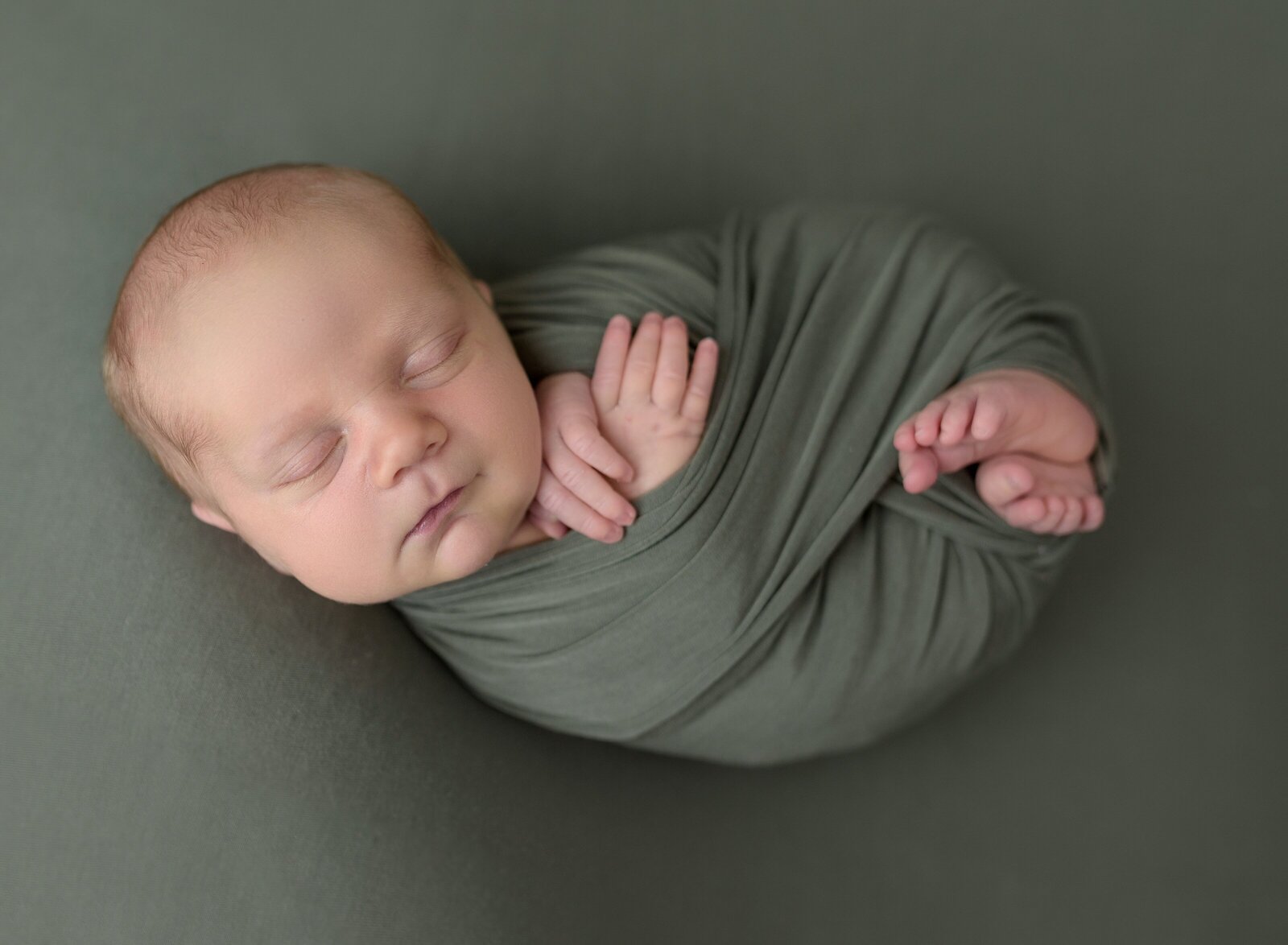 wrapped newborn in green