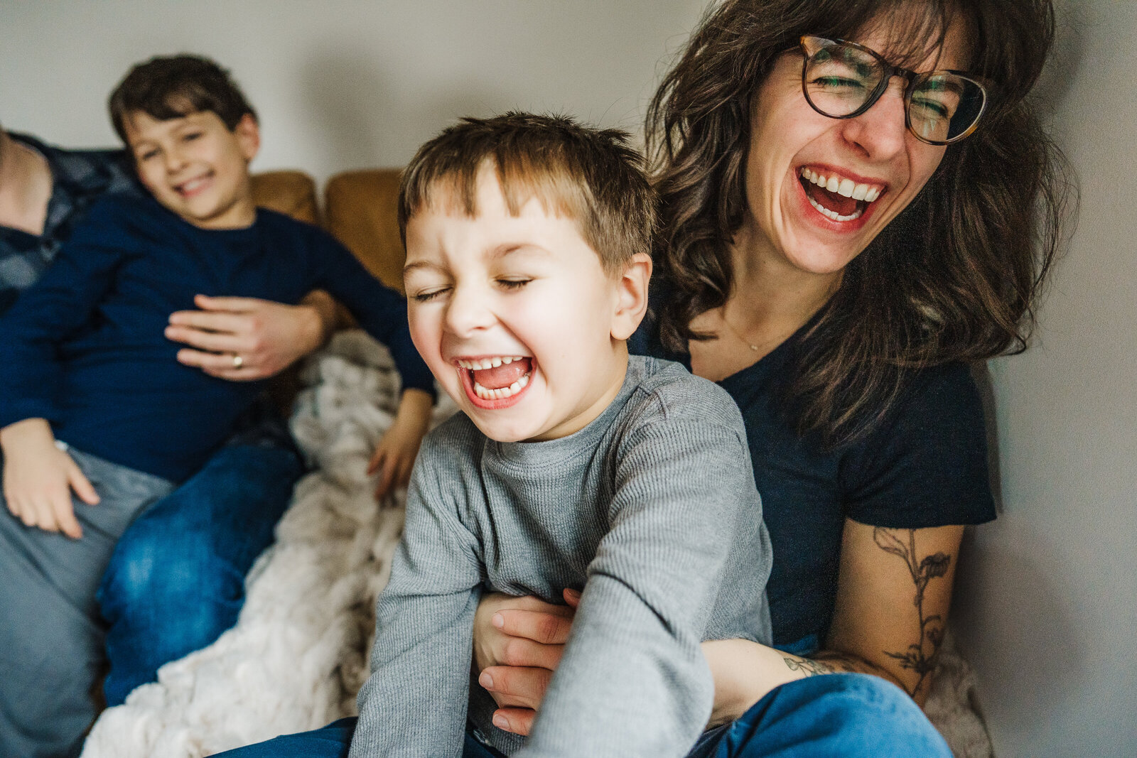 mom and son laugh together during family photos