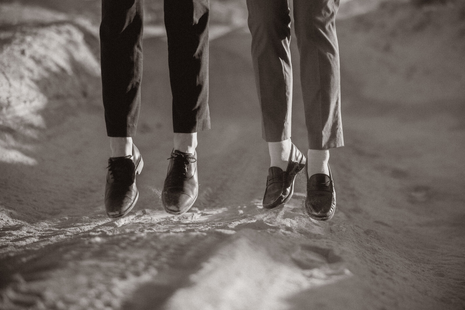 bride and groom holding each other on top of a mountain