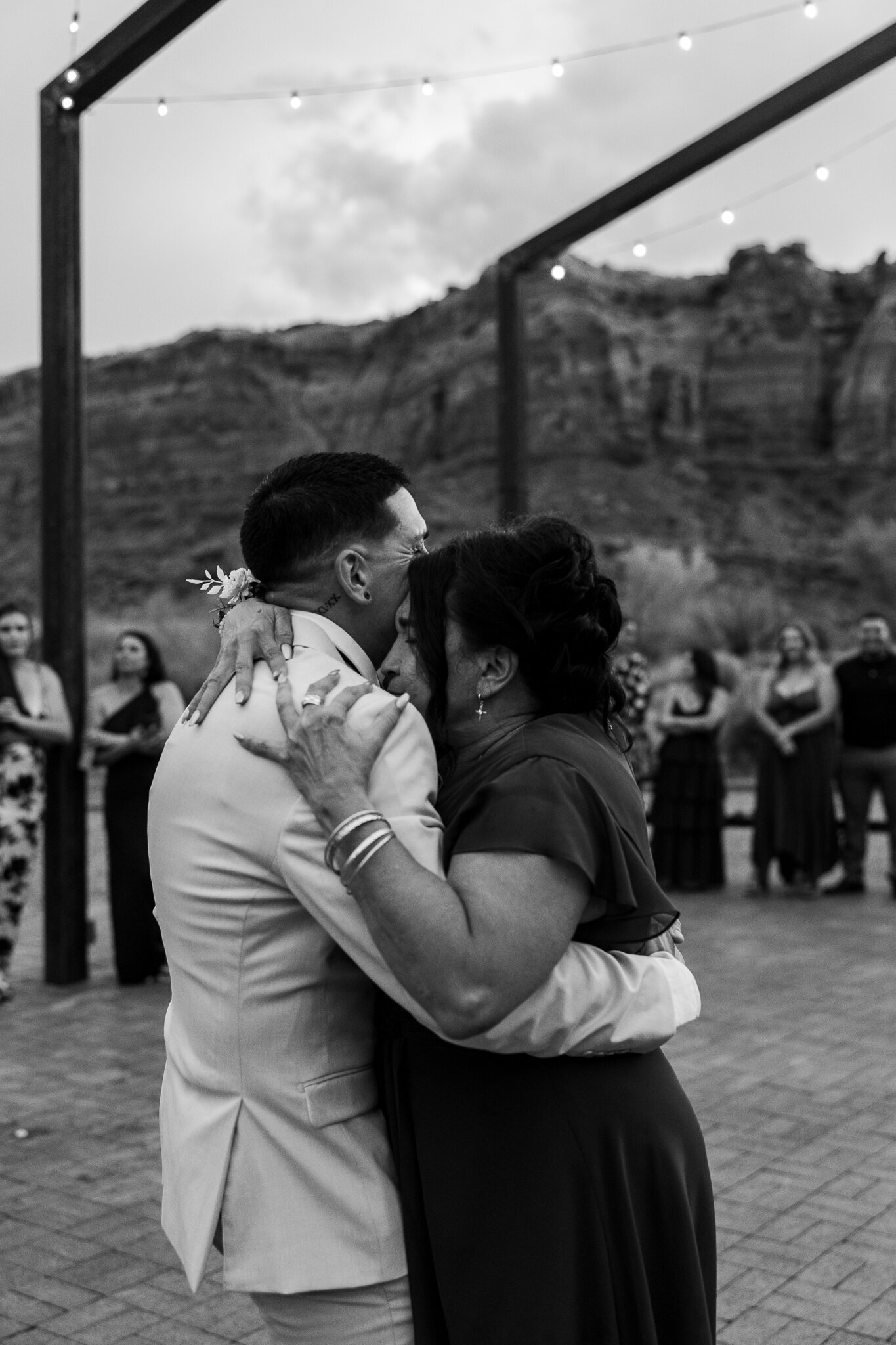 Mom hugs her son, the groom, at his utah wedding