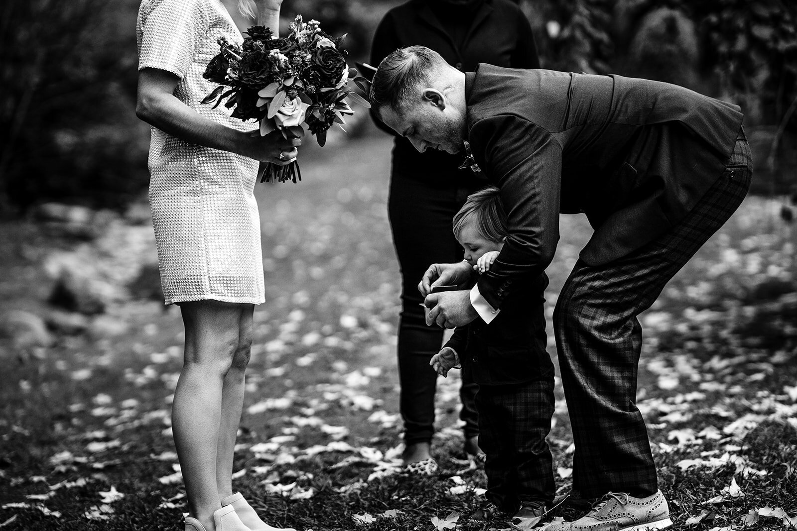 black and white of toddler ring bearer at a ceremony