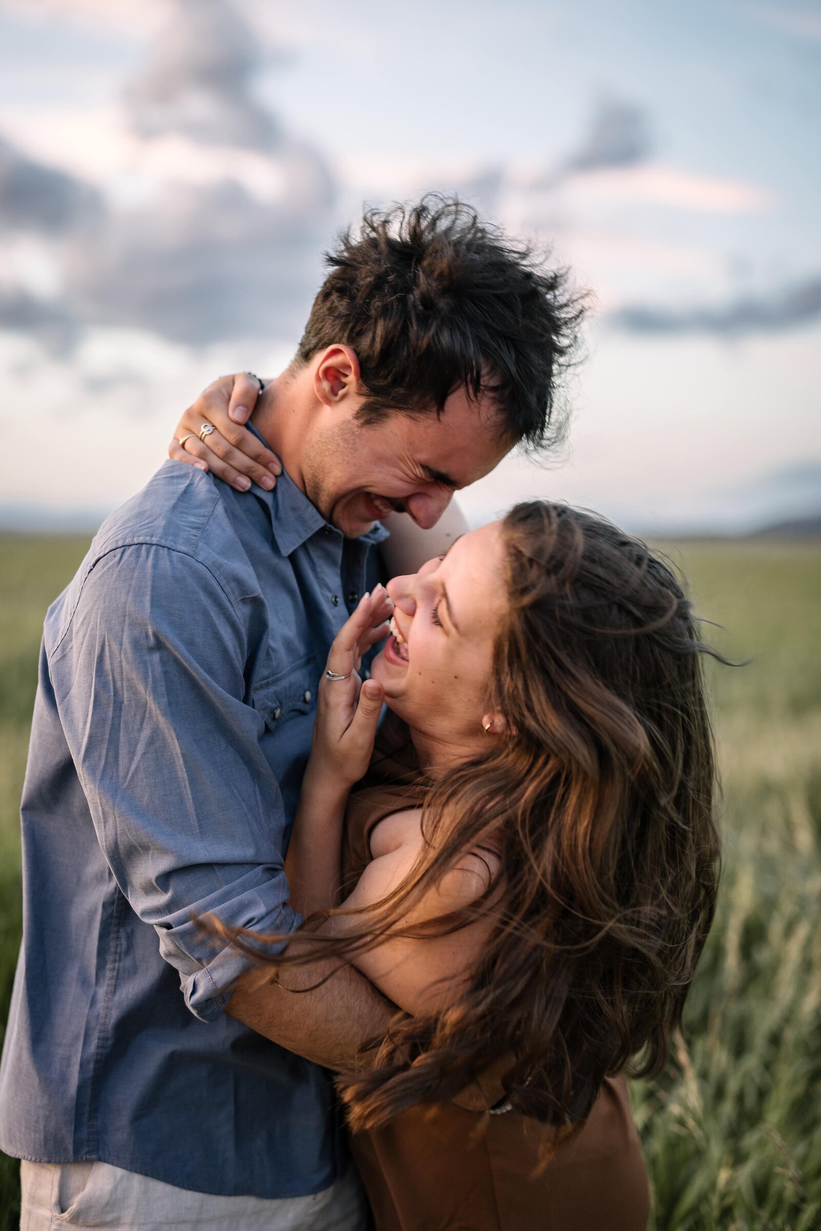 bride and groom laughing together in Jackson Hole engagement photos
