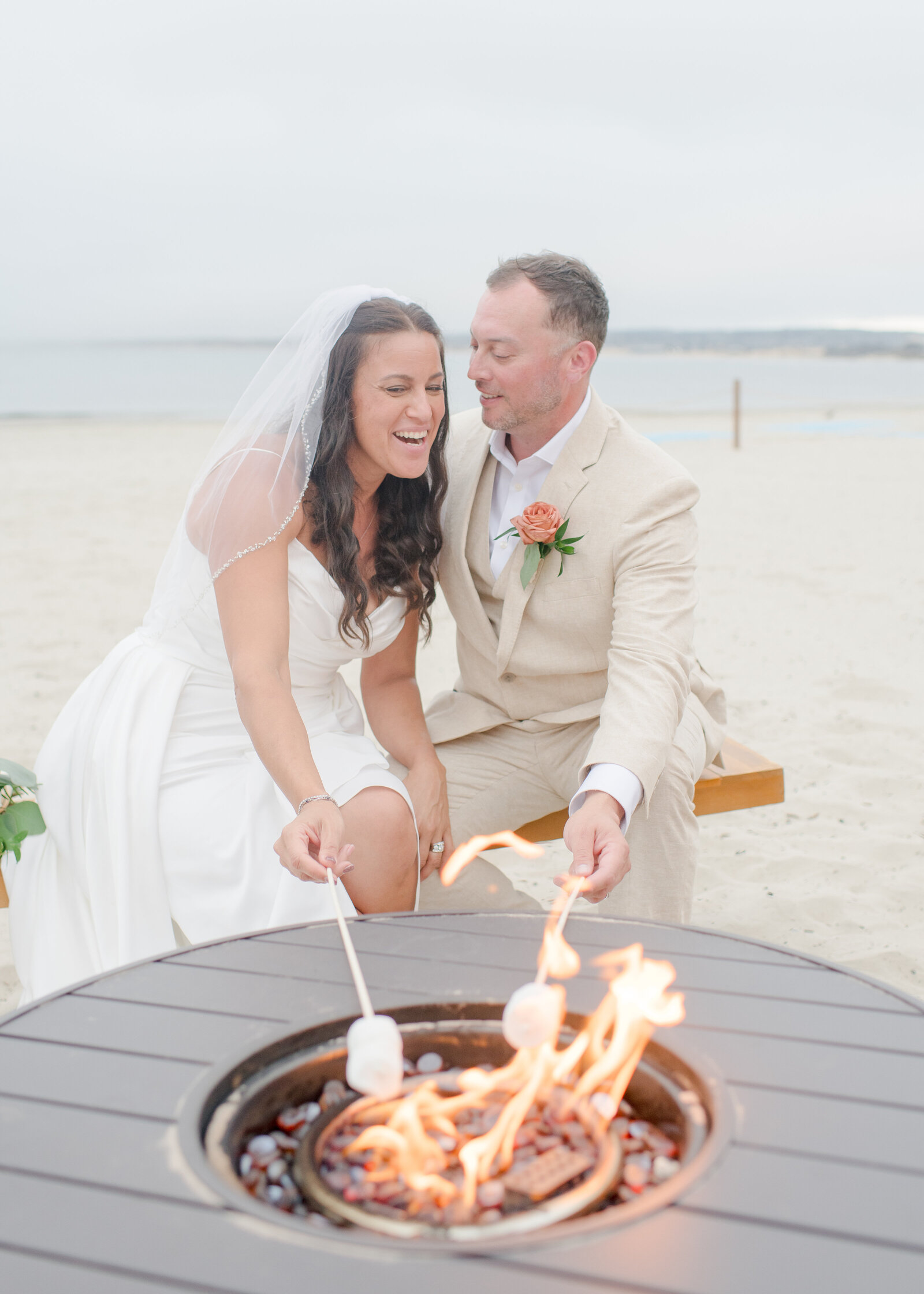 bride and groom roasting marshmallows