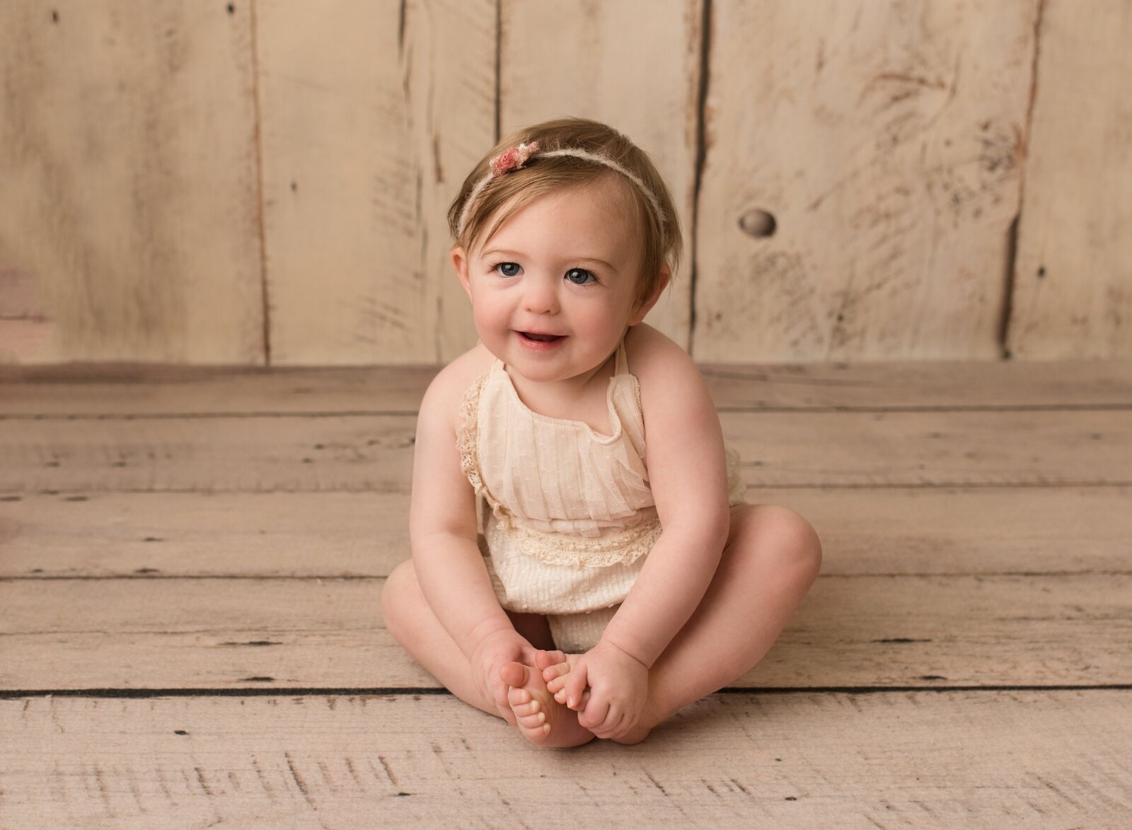 little girl posing in a studio for her first birthday pictures