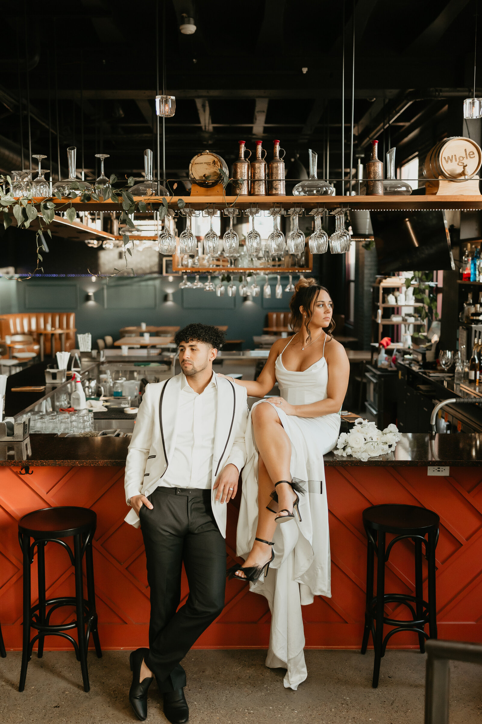 Hispanic Bride and Groom Sitting on Bar Counter