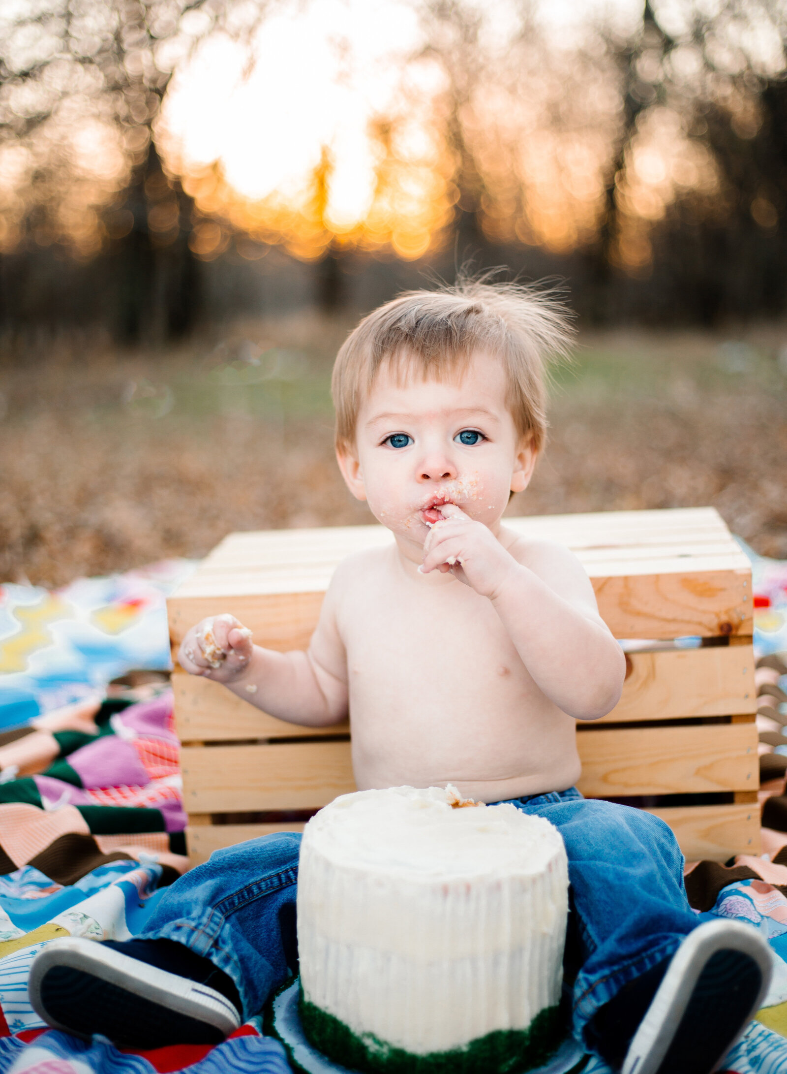 boy eating birthday cake in golden hour light