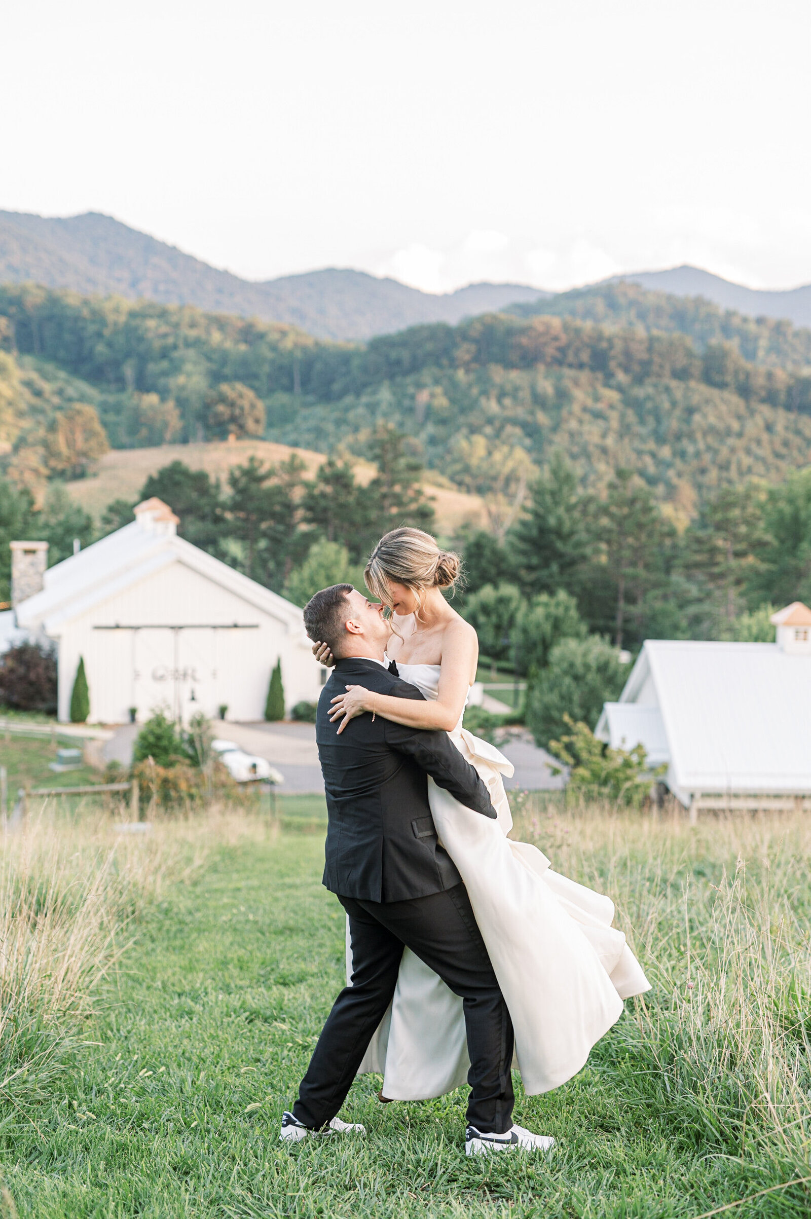 joyful bride and groom spinning elegant summer mountain wedding Chestnut Ridge Asheville NC