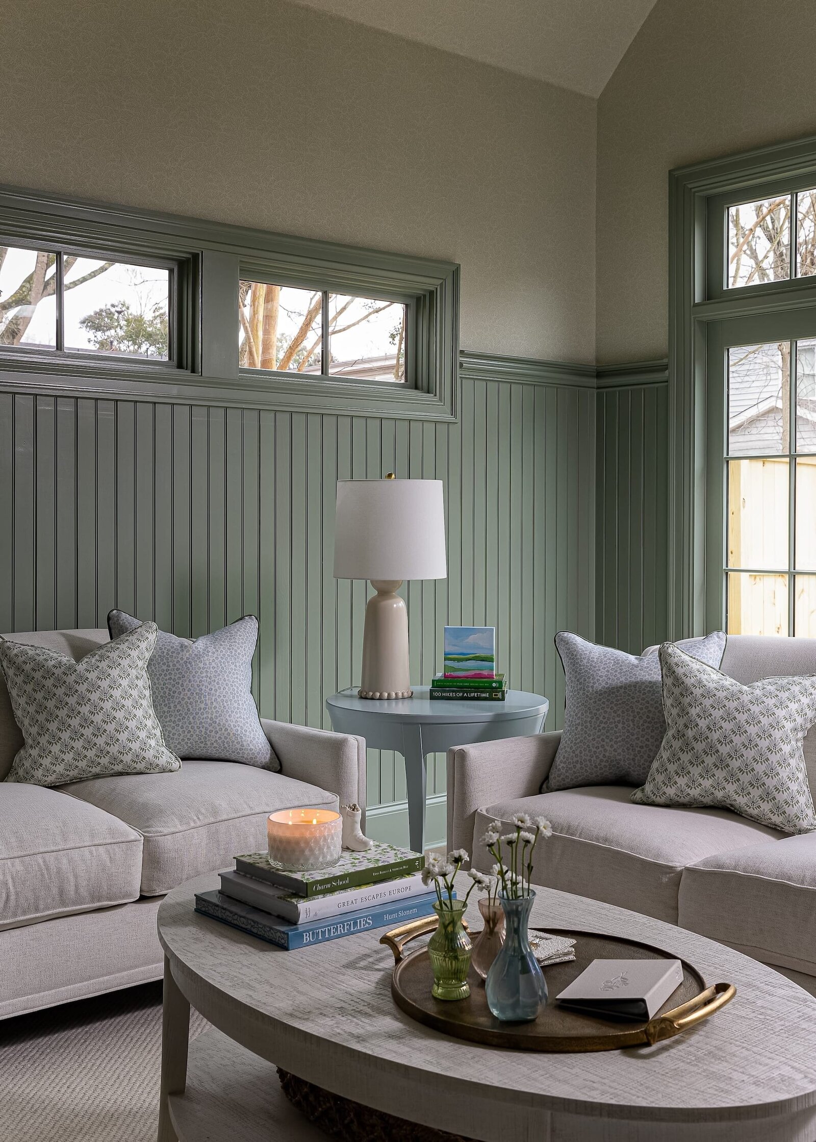 melinda chesson interiors carriage house living room with whtie couches and lamp on sidetable