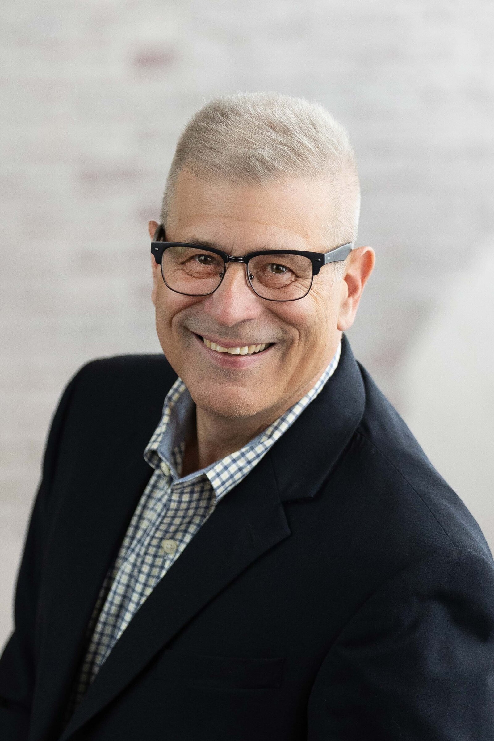 man in a black suite smiling