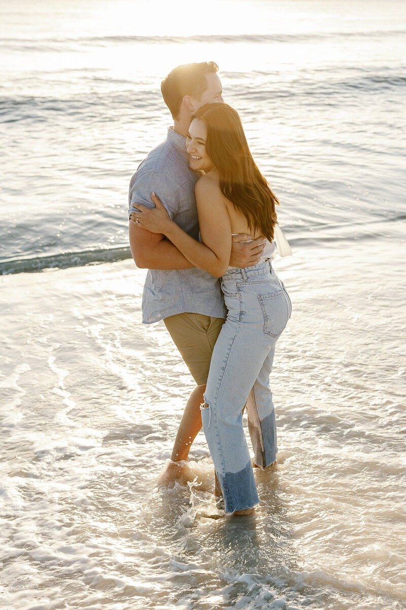 couple embracing in naples beach florida