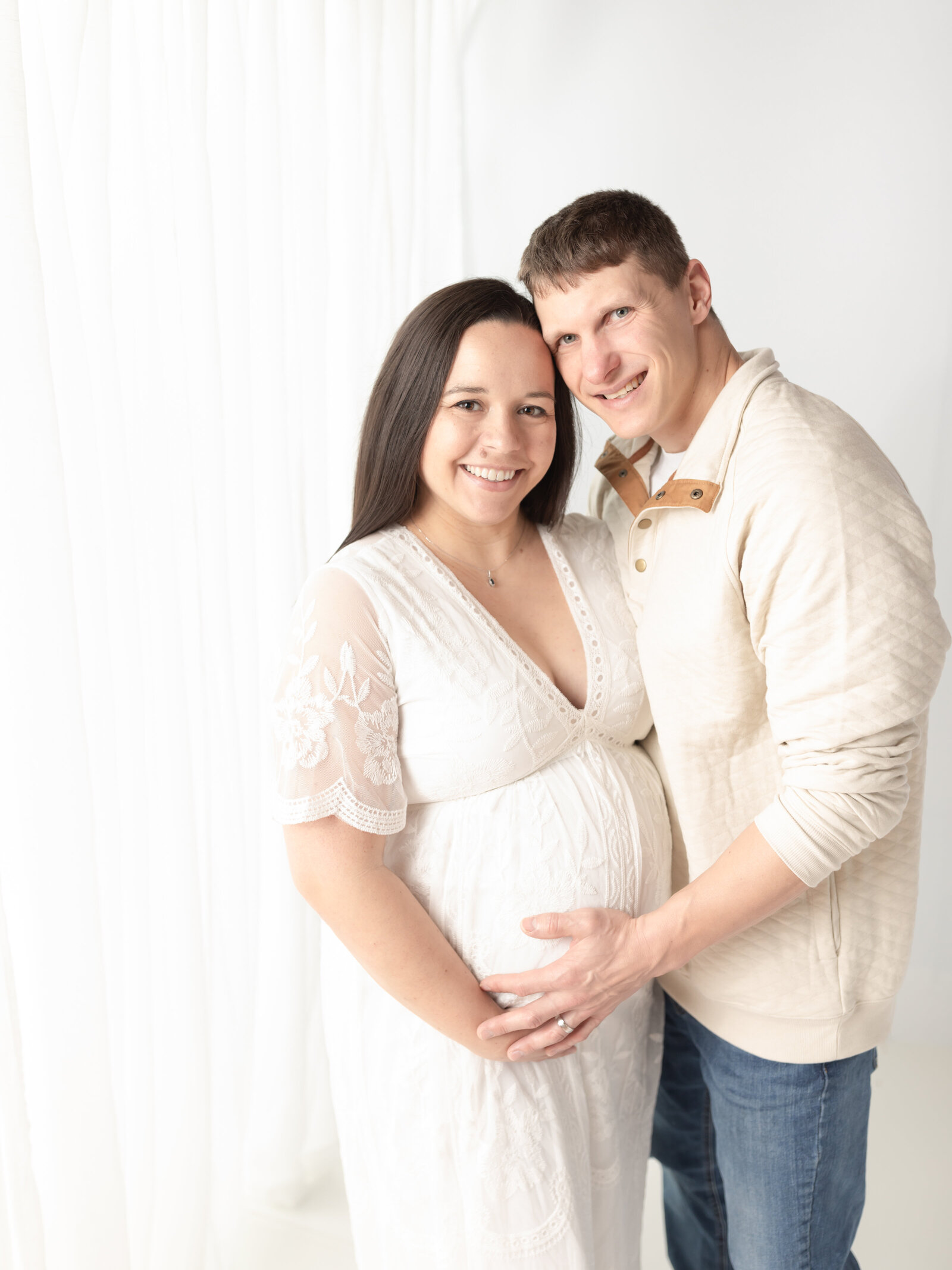 husband and pregnant wife holding baby bump for maternity photos Cleveland maternity photographer