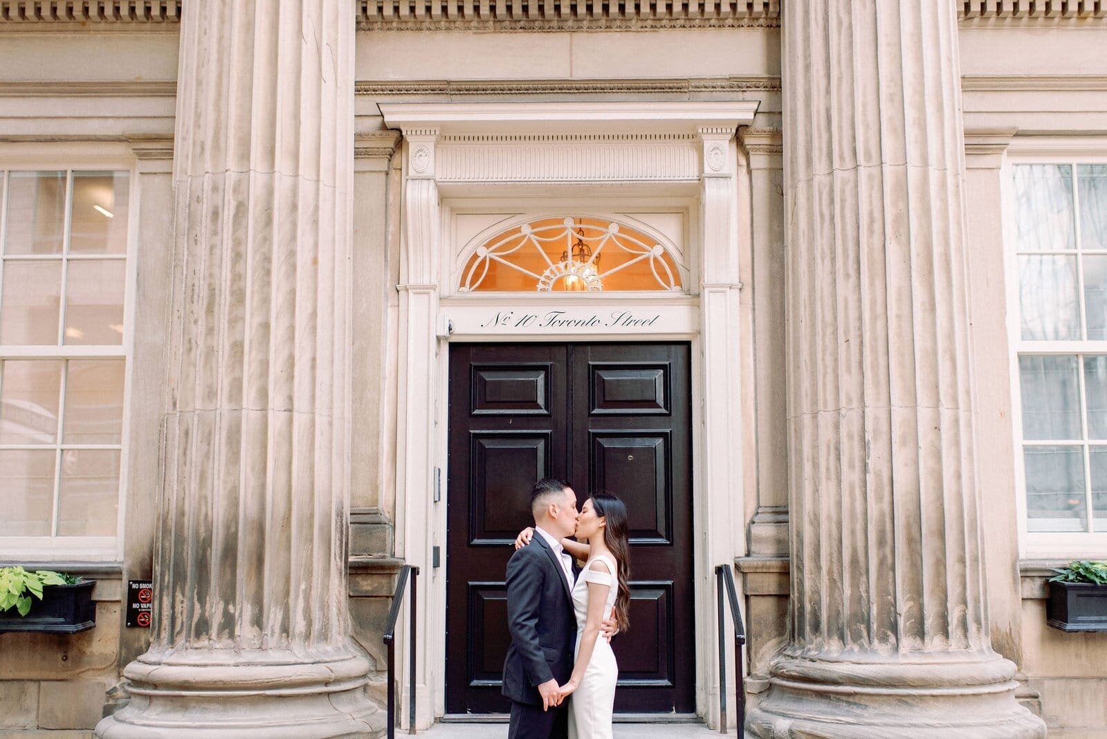 Modern Editorial Couple Embrace in front of Toronto Post Office Engagement Downtown Financial District Romantic Jacqueline James Photography