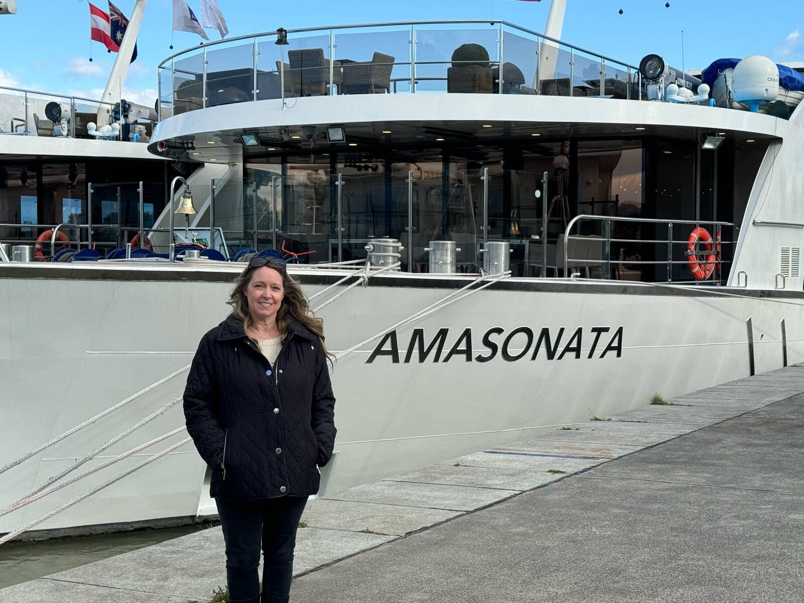 Travel Advisor Adventures by Terra standing in front of the AmaSonata river cruise ship in Vienna Austria.