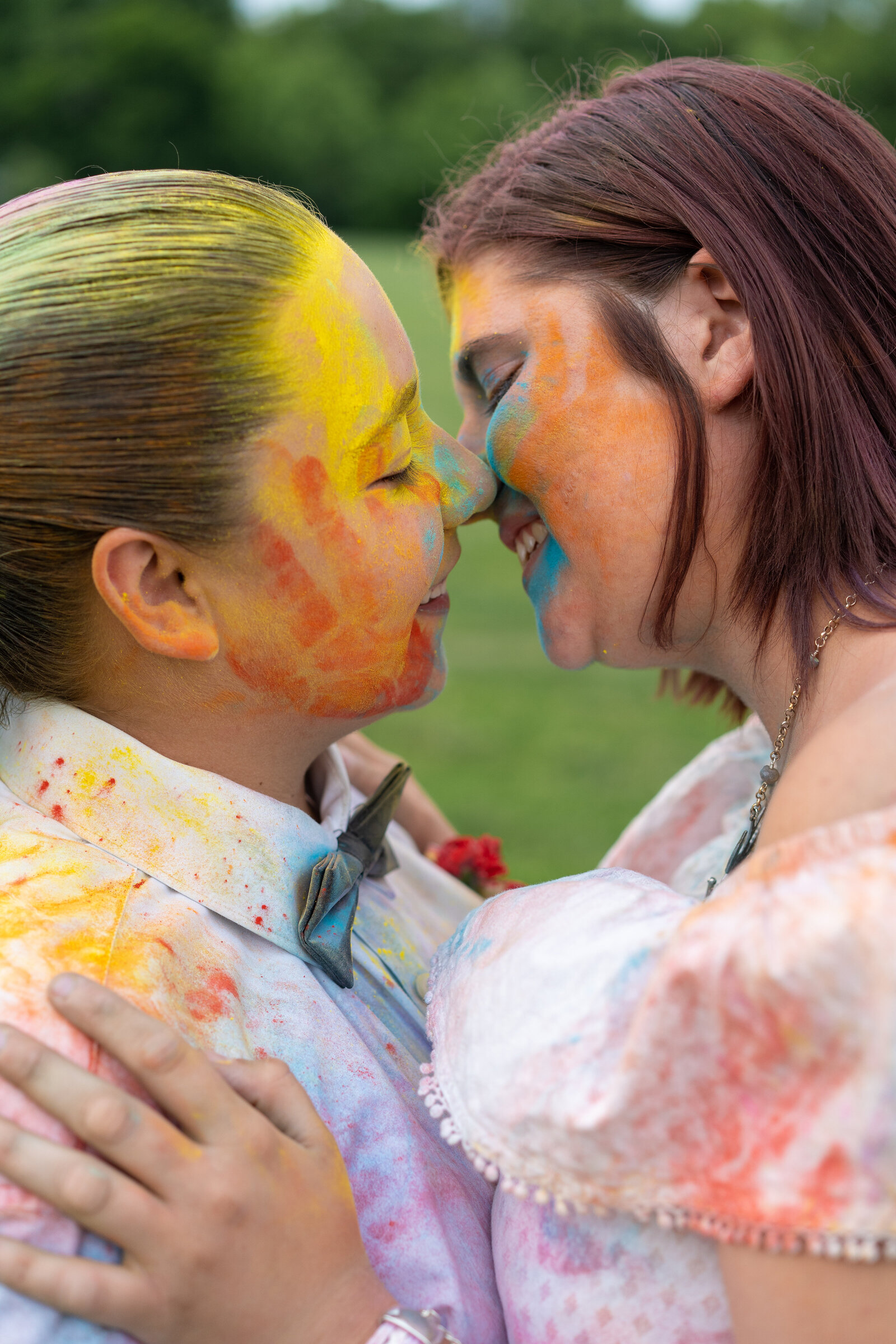 LGBTQ couple, Ivalee and Kara, embrace and move in for a kiss while covered in colored powder in Columbus, Ohio.