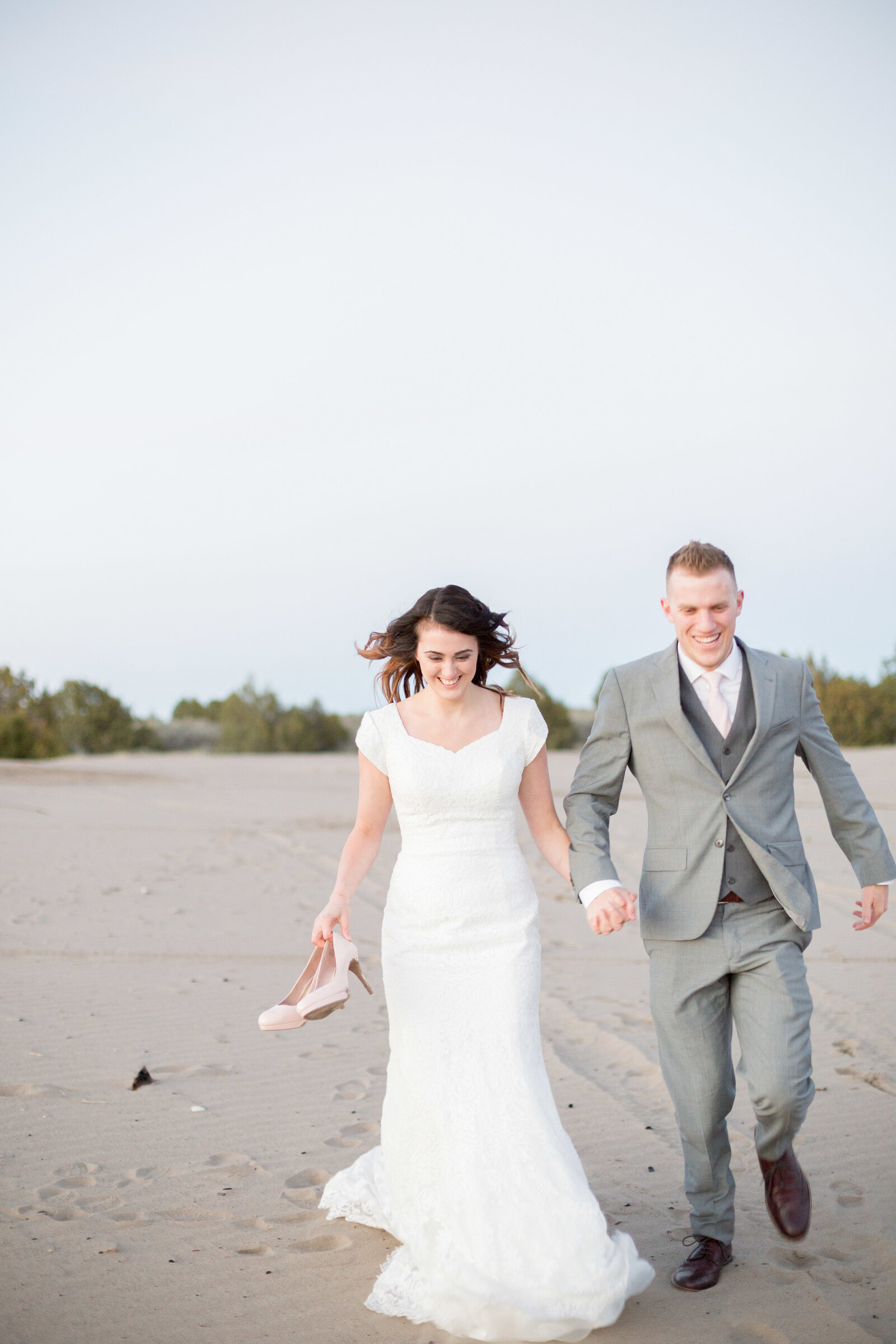 Idaho wedding photographers capture couple running in sand