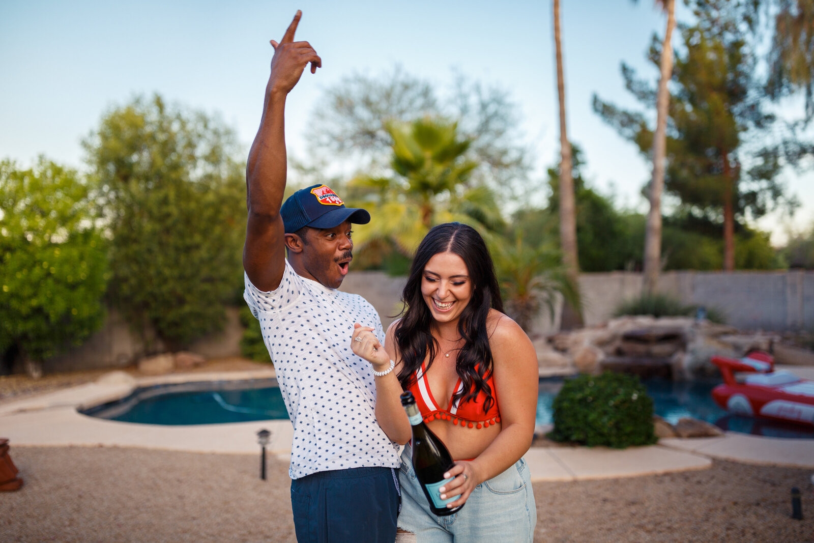 popping champagne during a fourth of july couples shoot