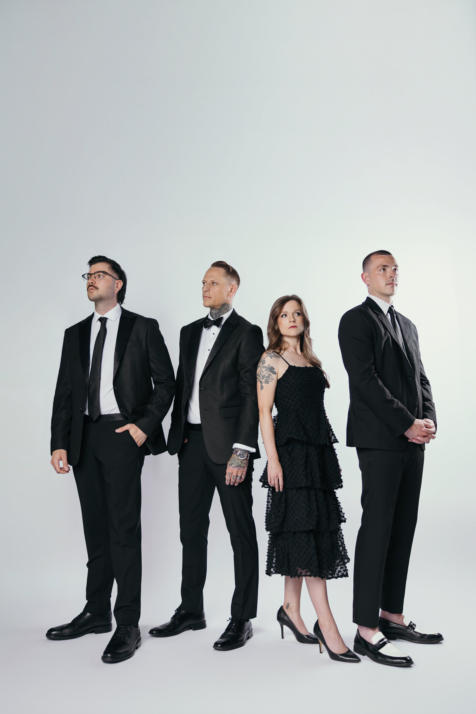 Editorial-style team portrait of The Proper Collective — luxury wedding film & photo creators in Des Moines.