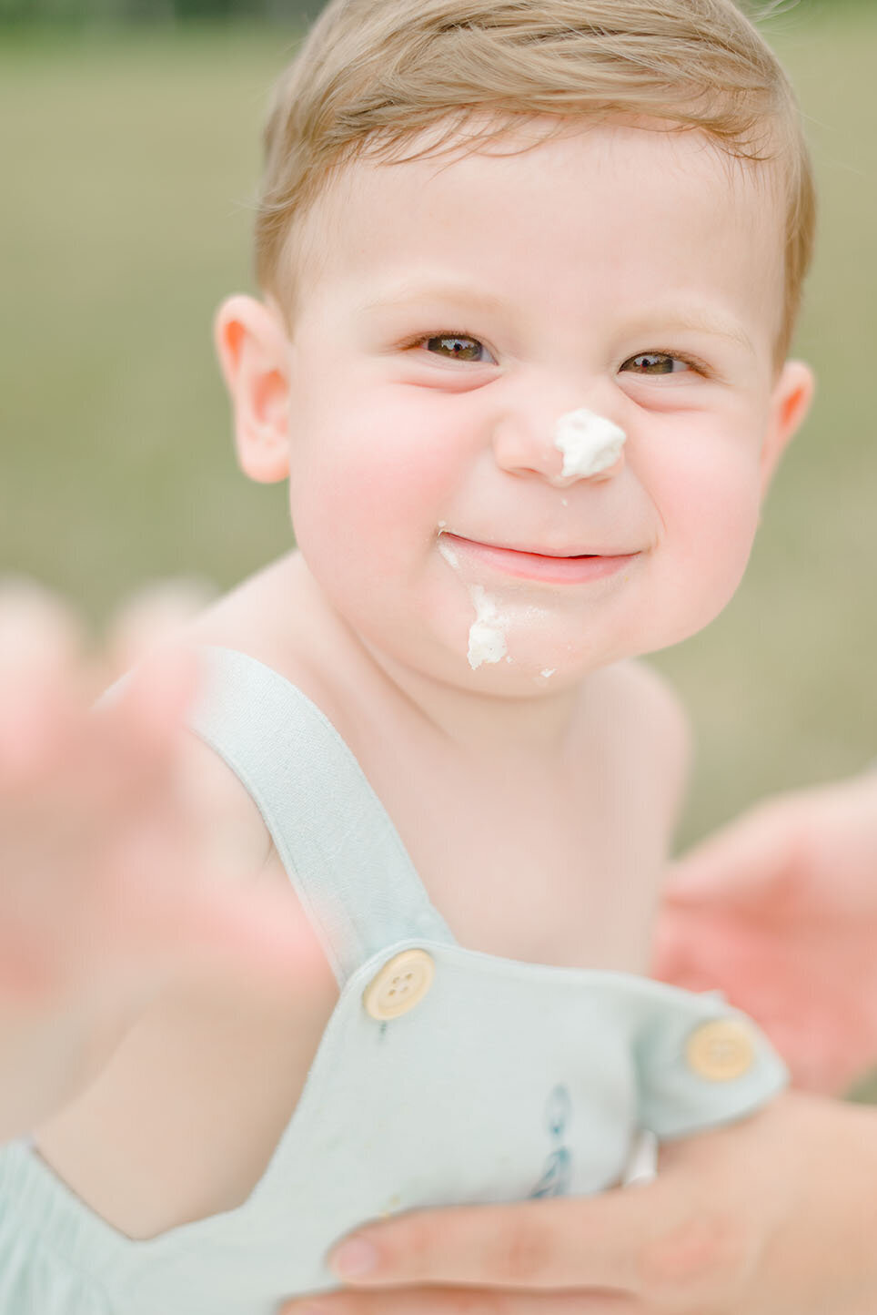 baby with icing on their nose during DMV milestone session