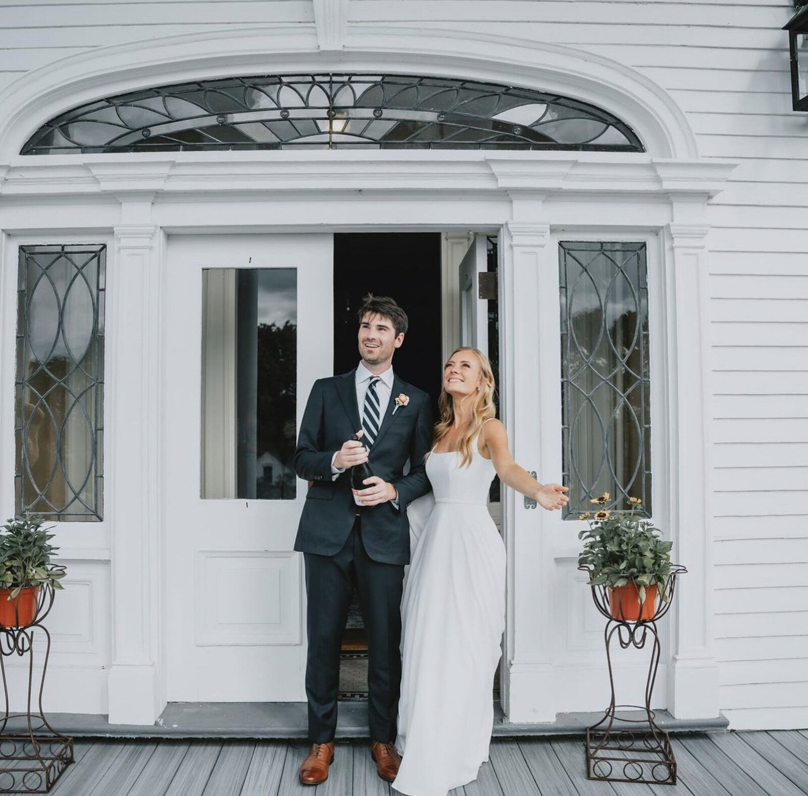 bride and groom standing together in front of their wedding reception area