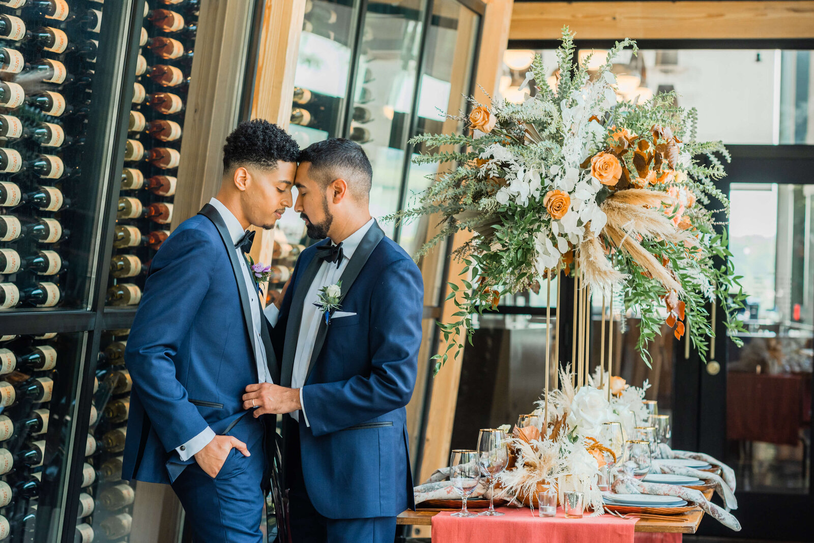 groom and groom kissing in winery reception area
