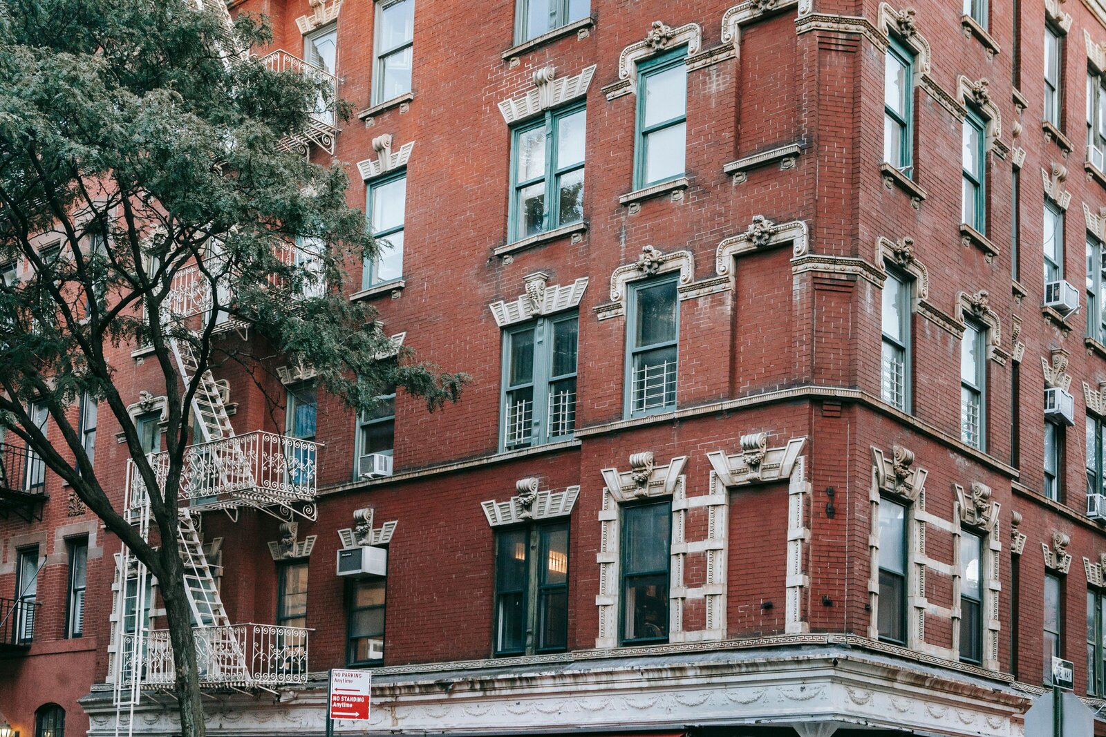 Luxury apartment building in NYC with fire escapes and architectural details