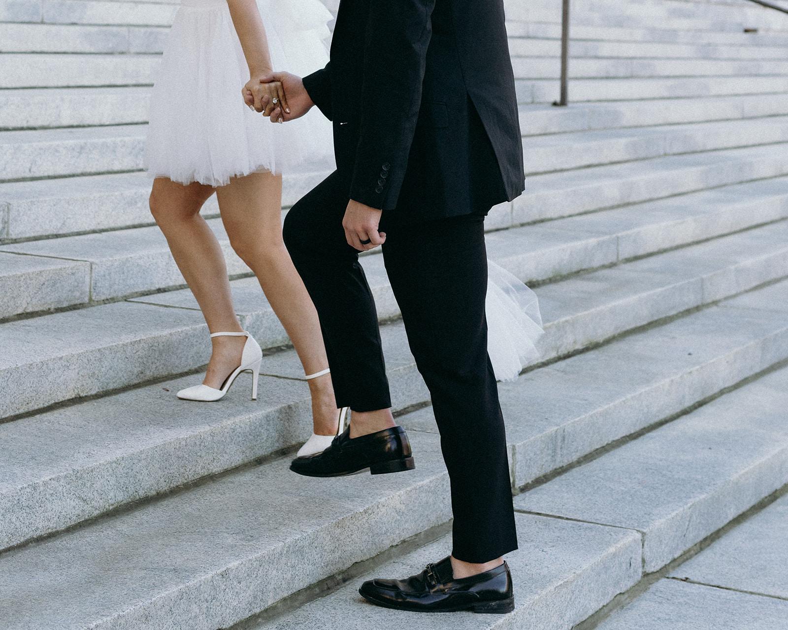 Recently married couple walking up the steps of the courthouse celebrating their life as newlyweds | Megan Smith Photography