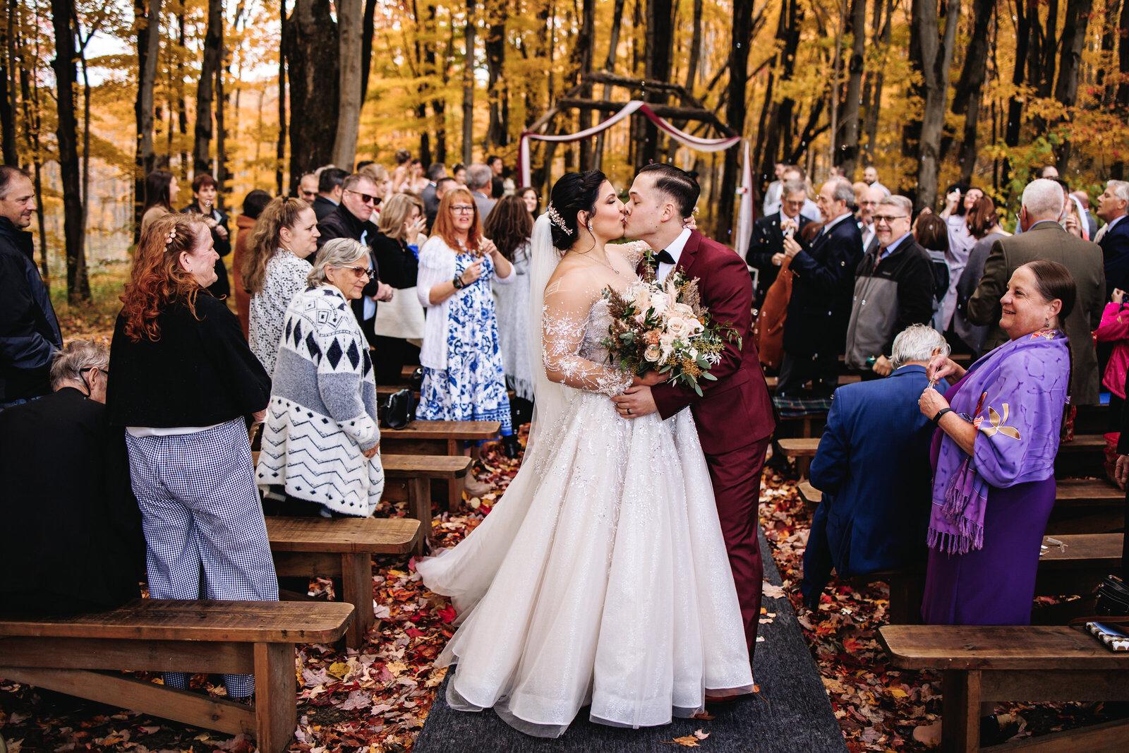 Bride and groom stop for a kiss before exiting their wedding ceremony