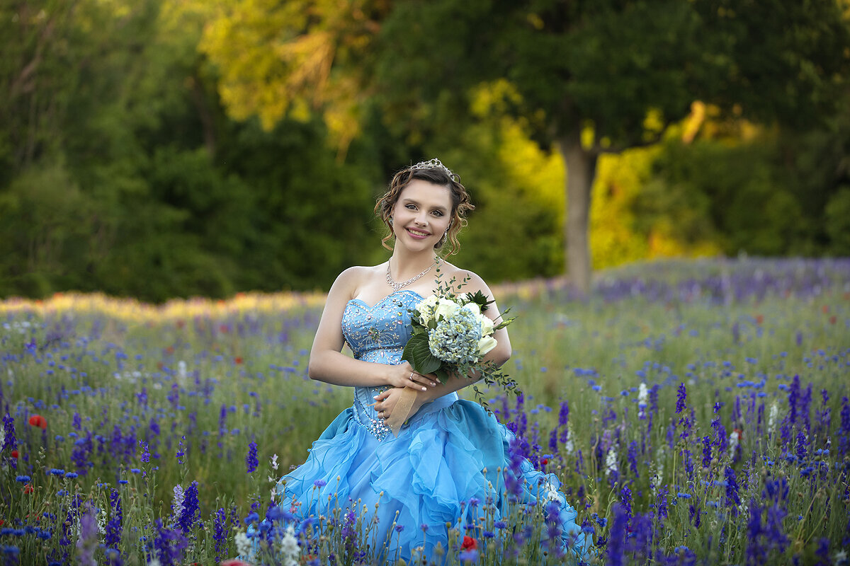 Dallas senior girl poses in wildflower field in prom dress