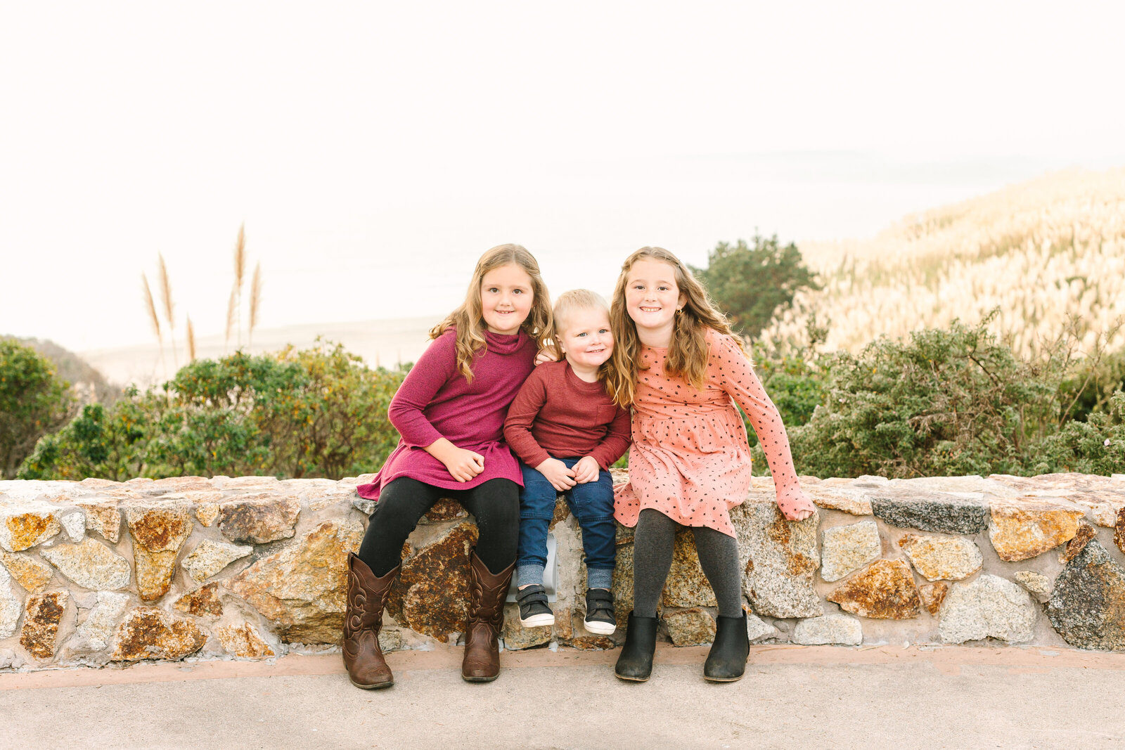 A family poses for photos along the beach in Santa Cruz, Ca.