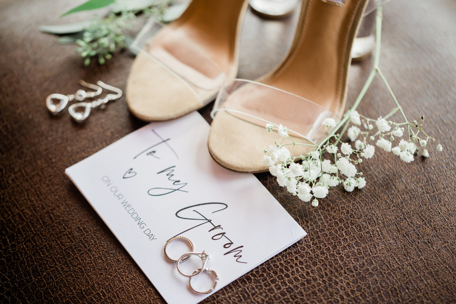 detail shot of the brides show and some florals and rings