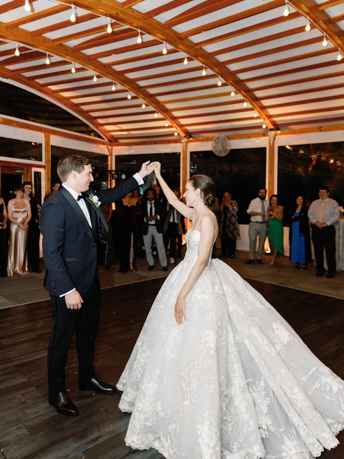 Bride and groom first dance at wedding under tent.