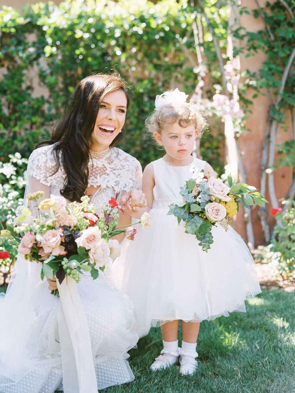 Bride with little flower girl at Rancho Valencia wedding  in San Diego